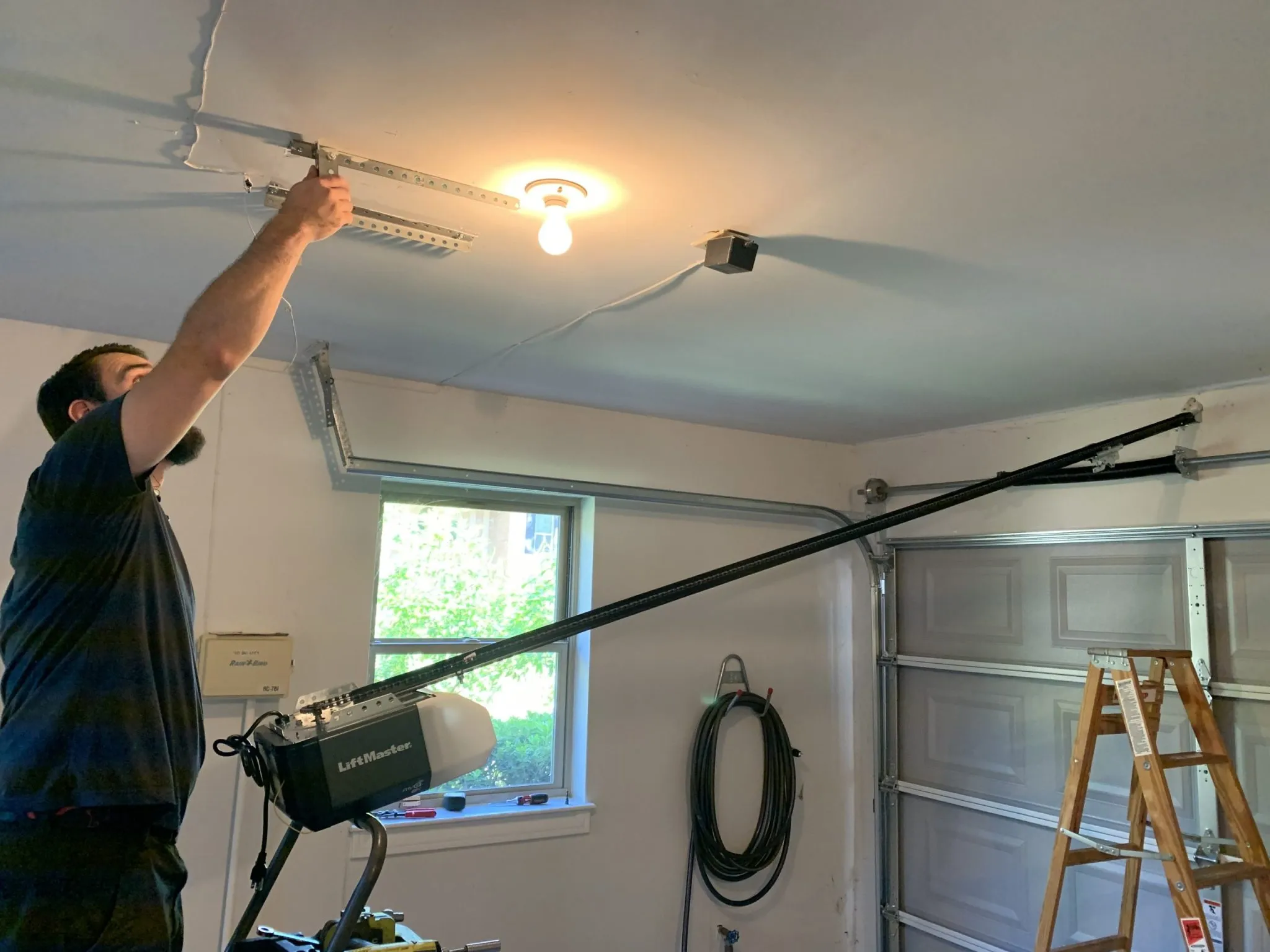 Technician servicing a LiftMaster garage door opener