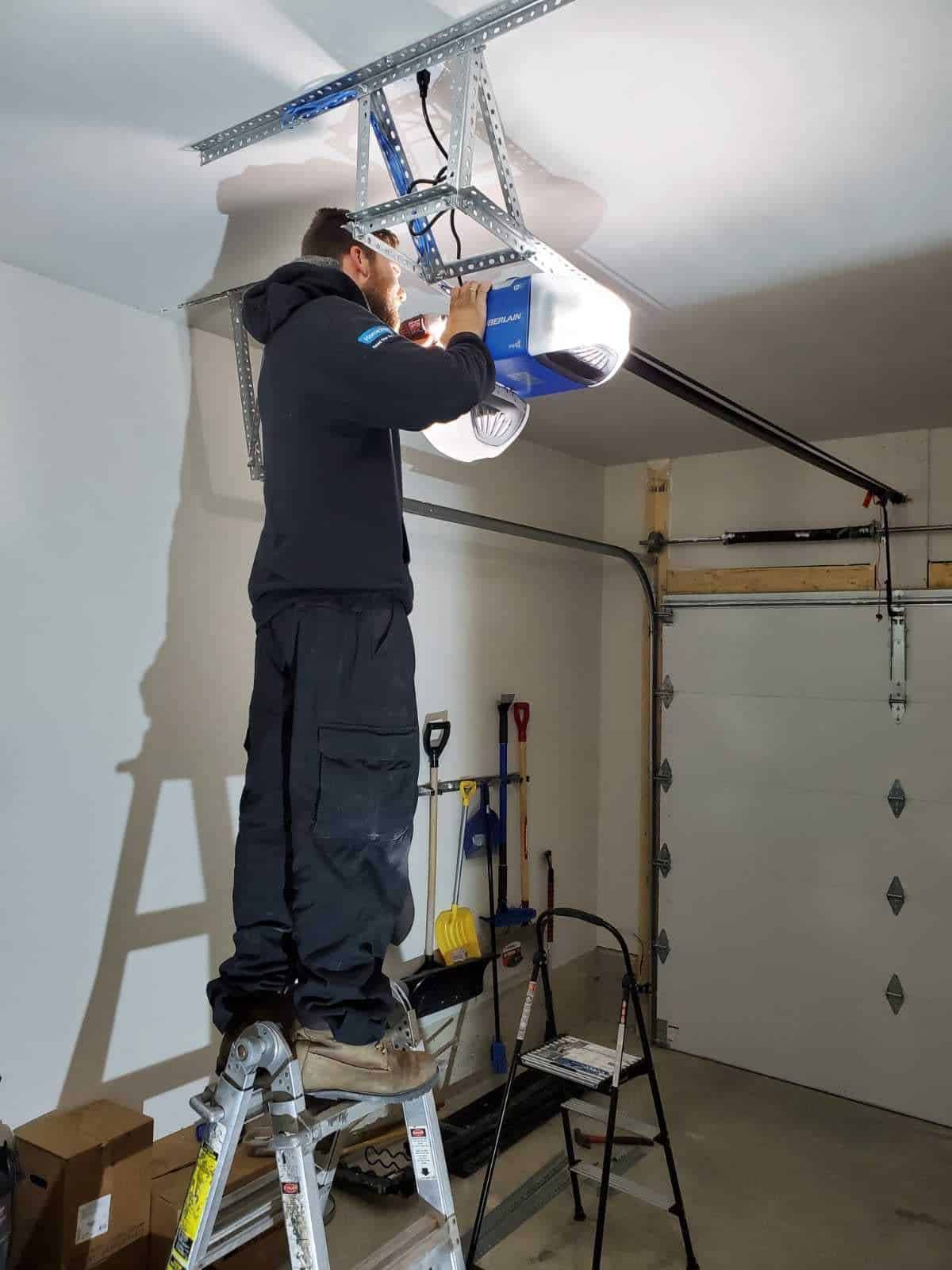 Technician installing a garage door opener