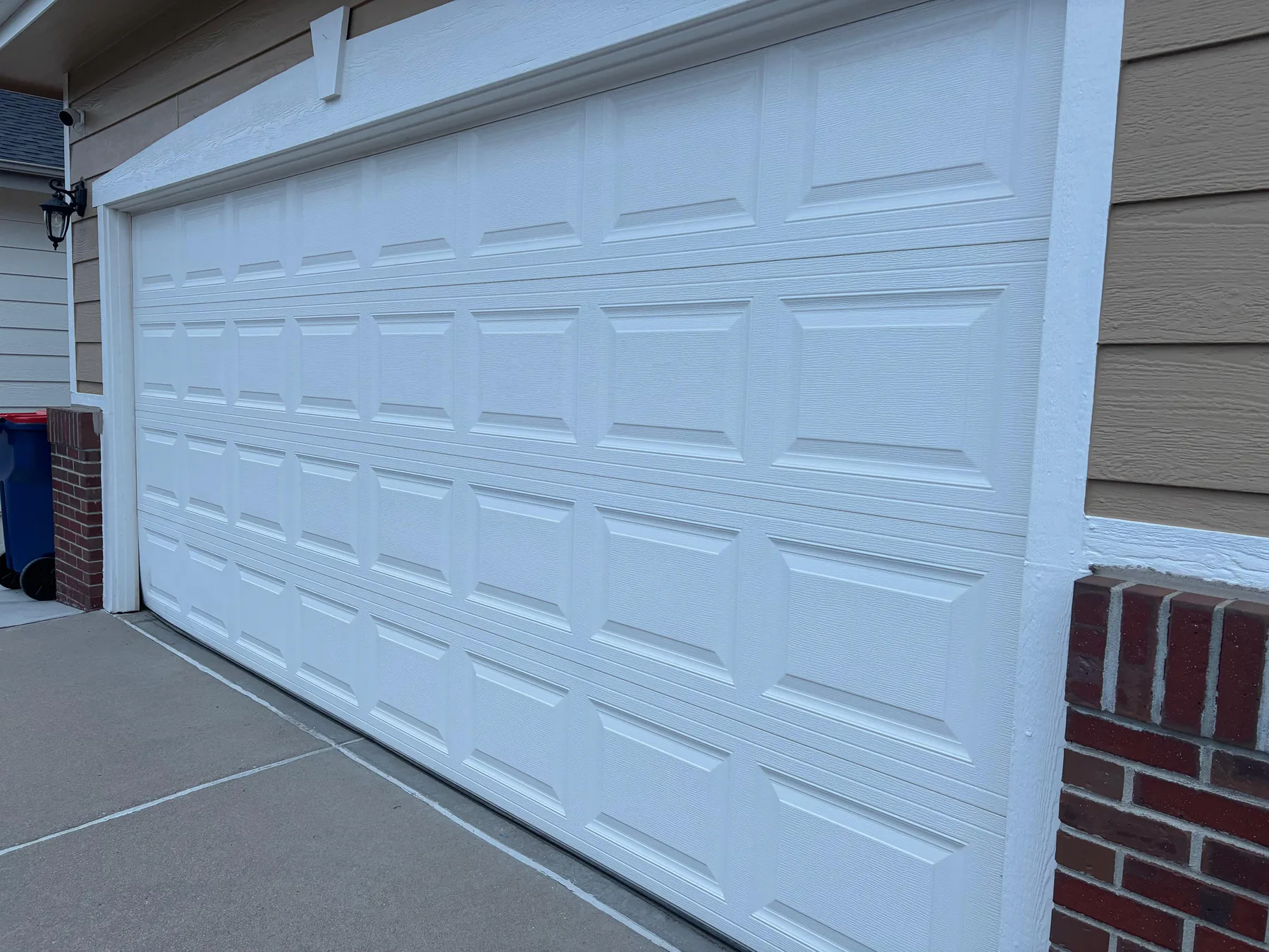 White short-panel garage door installed for a Fountain homeowner in August 2026