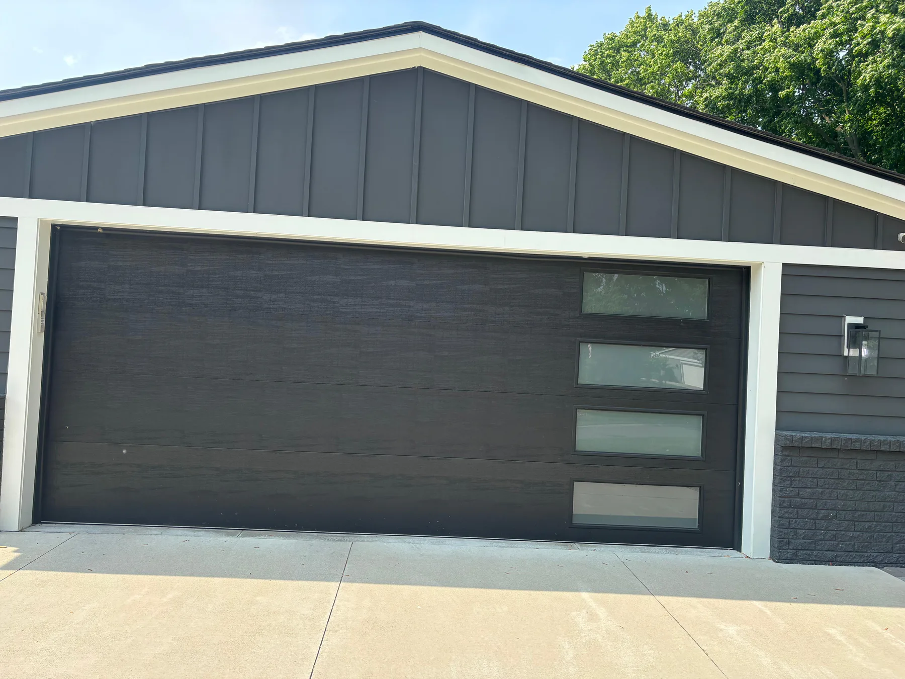 Modern gray garage door with vertical windows installed in Security-Widefield in March 2026